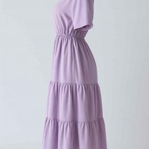 Side view of a modest lavender midi dress with elastic waist, short sleeves, and two softly gathered tiers